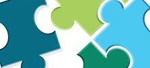 Illustration of four multi-coloured puzzle pieces interlocking.